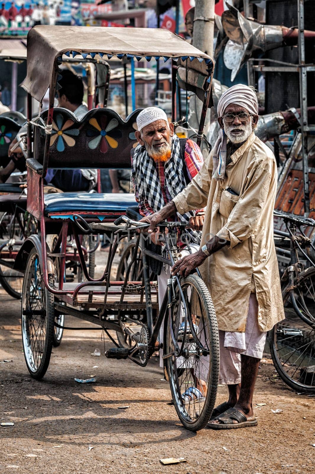AGRA, INDIA - NOVEMBER 21, 2012: Bicycle rickshaws in the street of Agra, Uttrar Pradesh, India