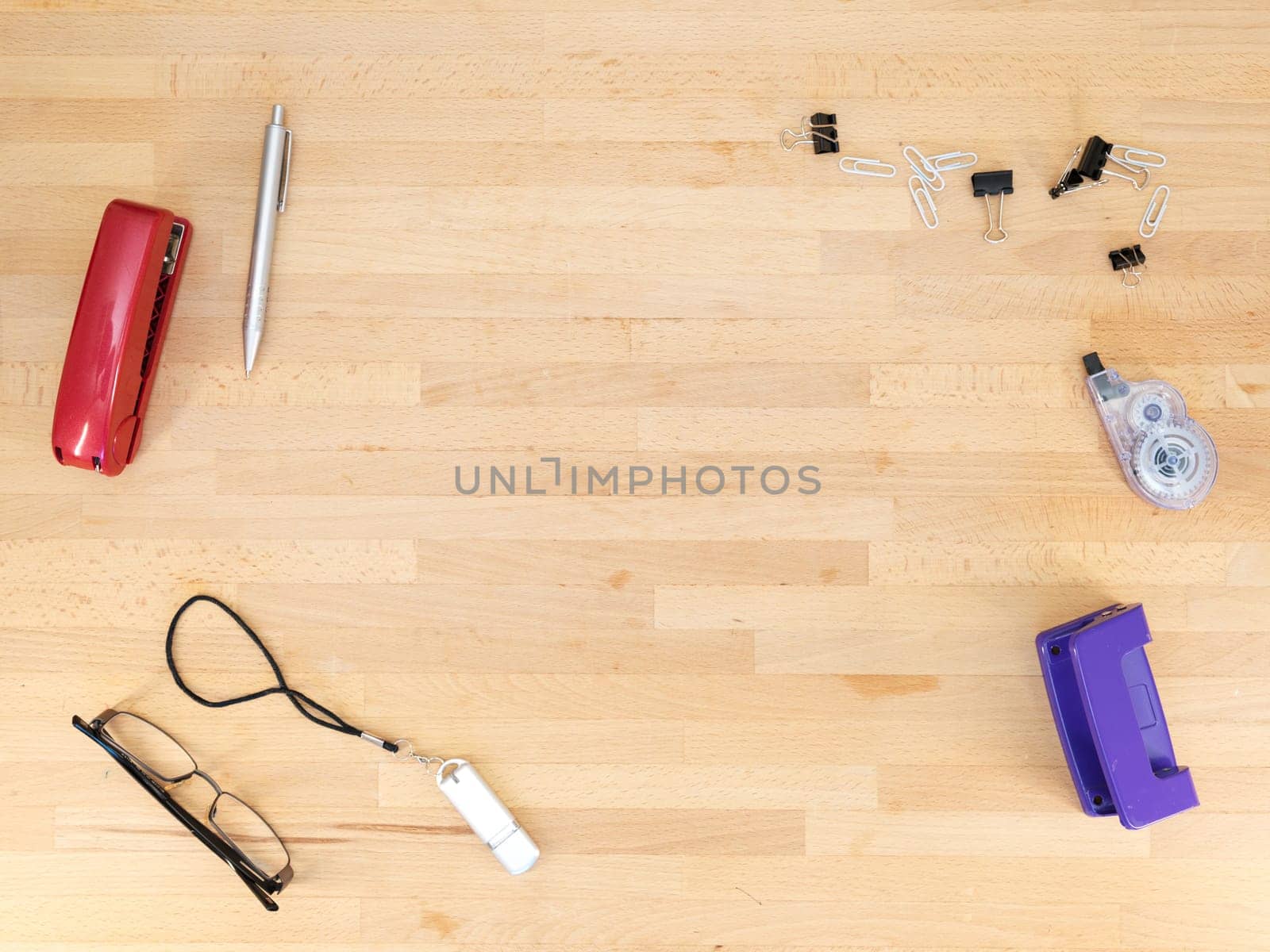 Stationery and work objects on a wooden  office desk