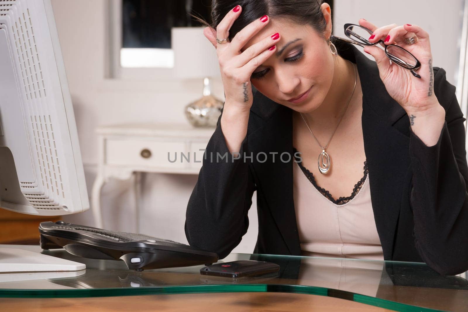 Woman at computer desks looks frustrated