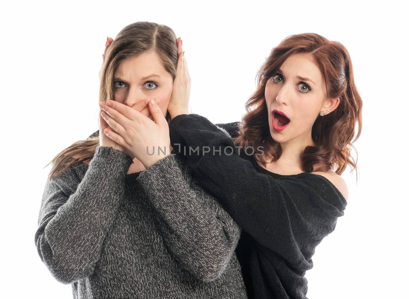 A girl holds her friend's ears