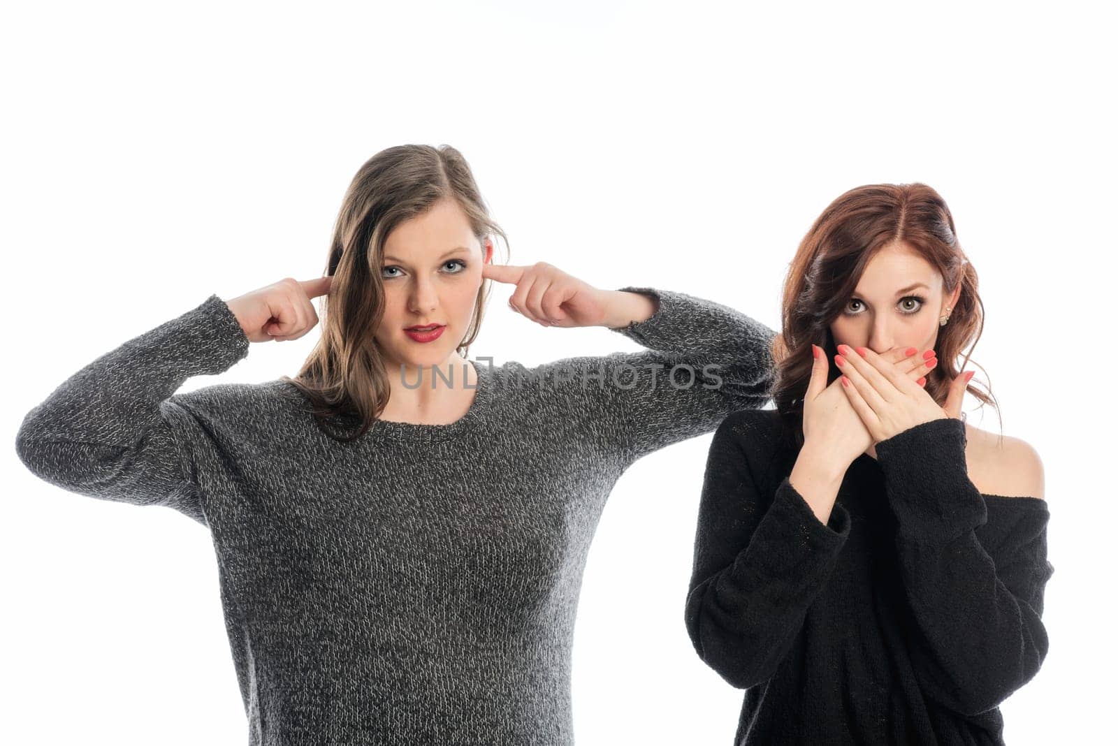 Girlfriends hold their ears and mouths