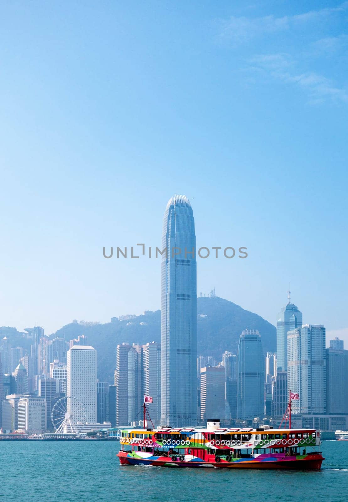 A ferry in Hong Kong harbour with the city skyline in the background