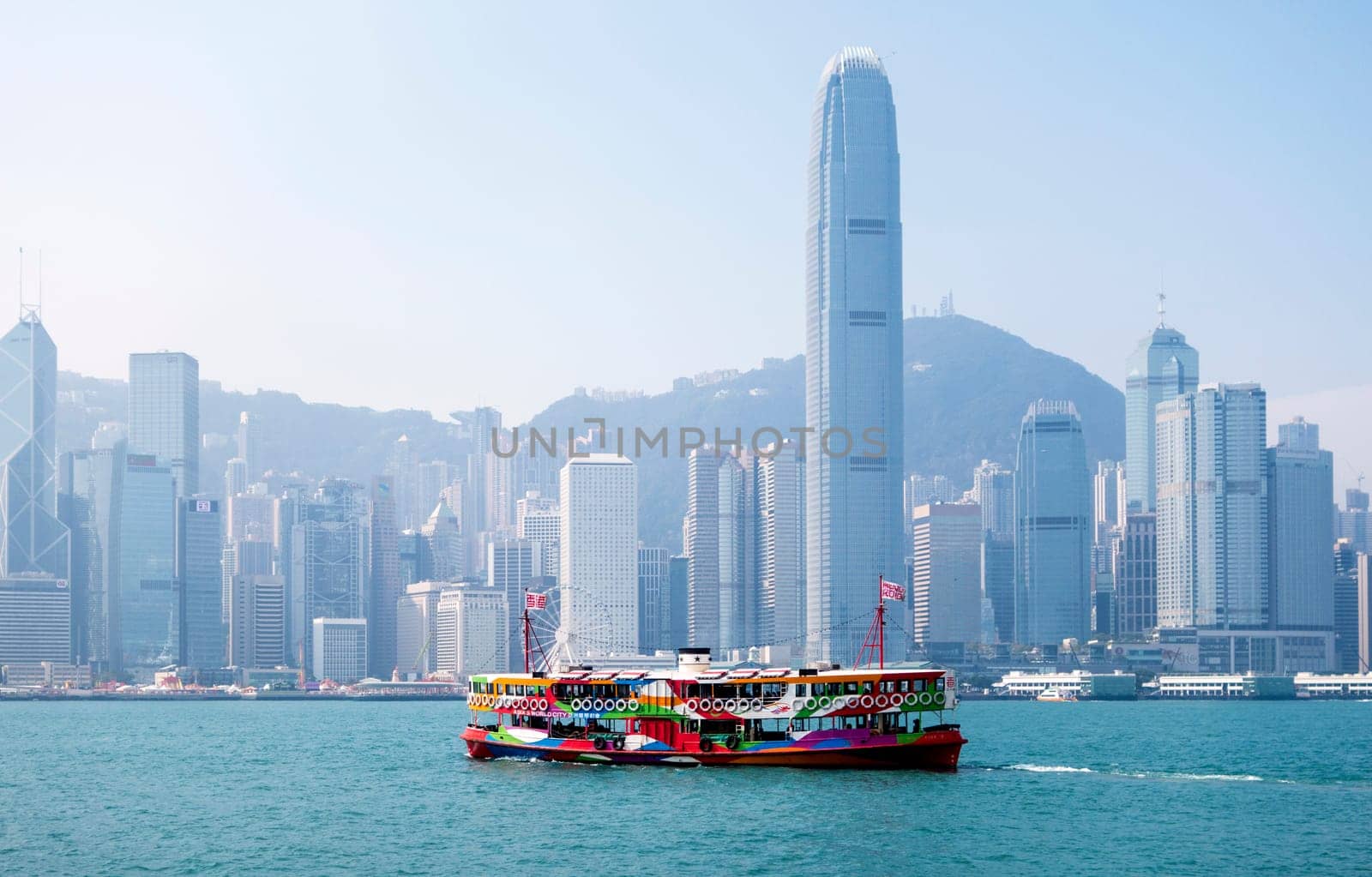 A ferry in Hong Kong harbour with the city skyline in the background