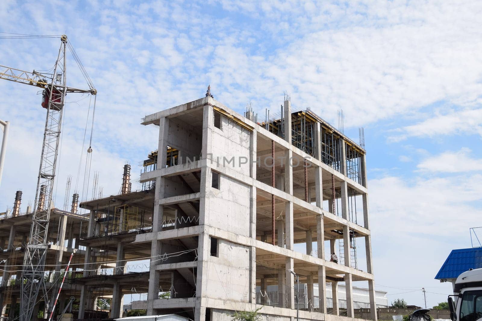 construction of multi-storey residential buildings. Tower cranes at a construction site.