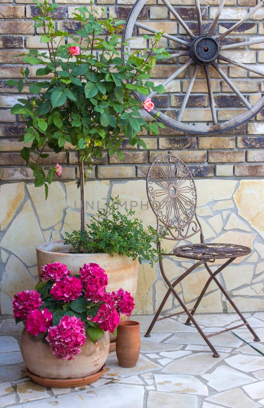 beautiful place in the garden in the mediterranean style, pots with flowers