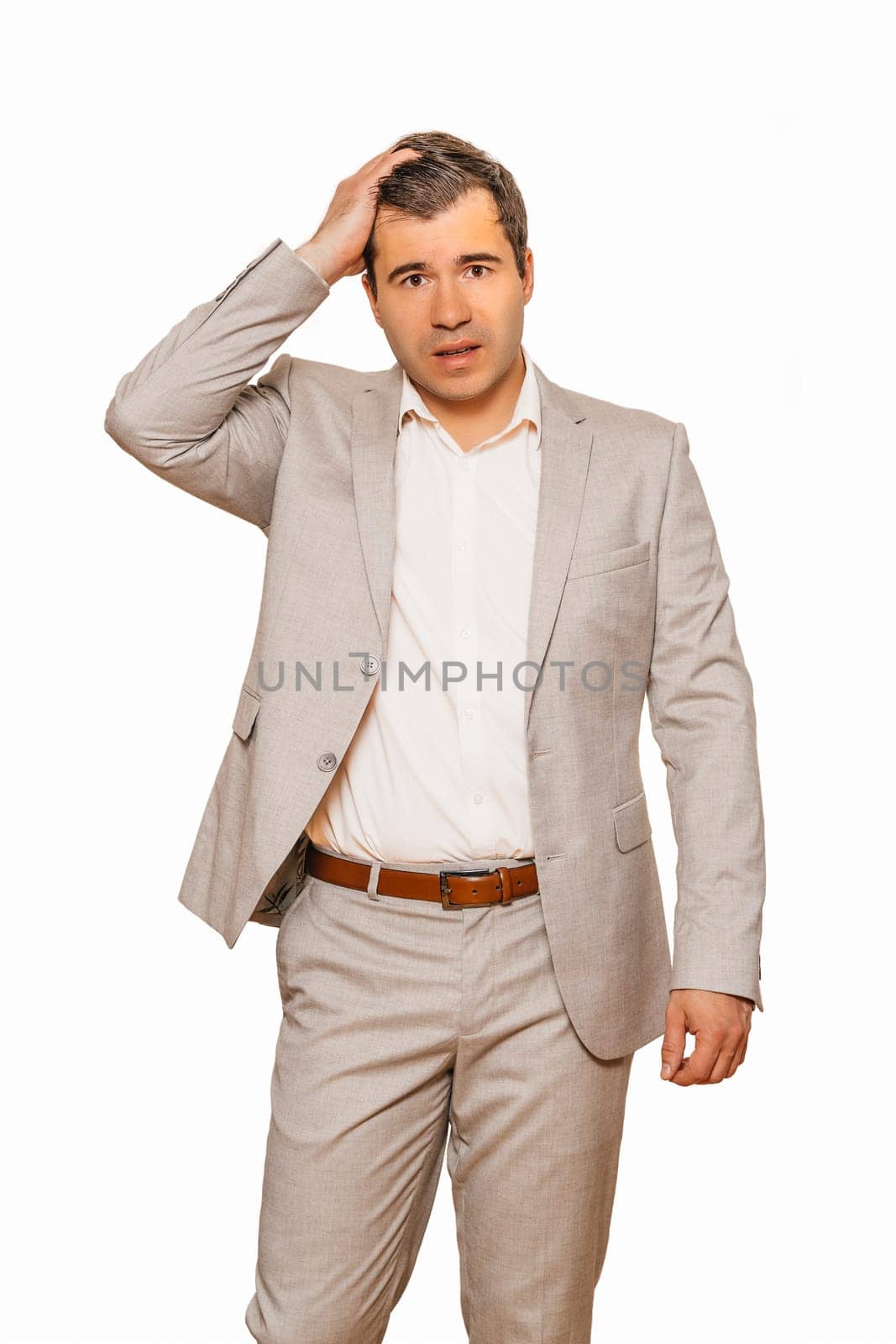 Middle age businessman in beige suite, depressed and in shock as his business falling during recession of coronavirus, isolated on white background