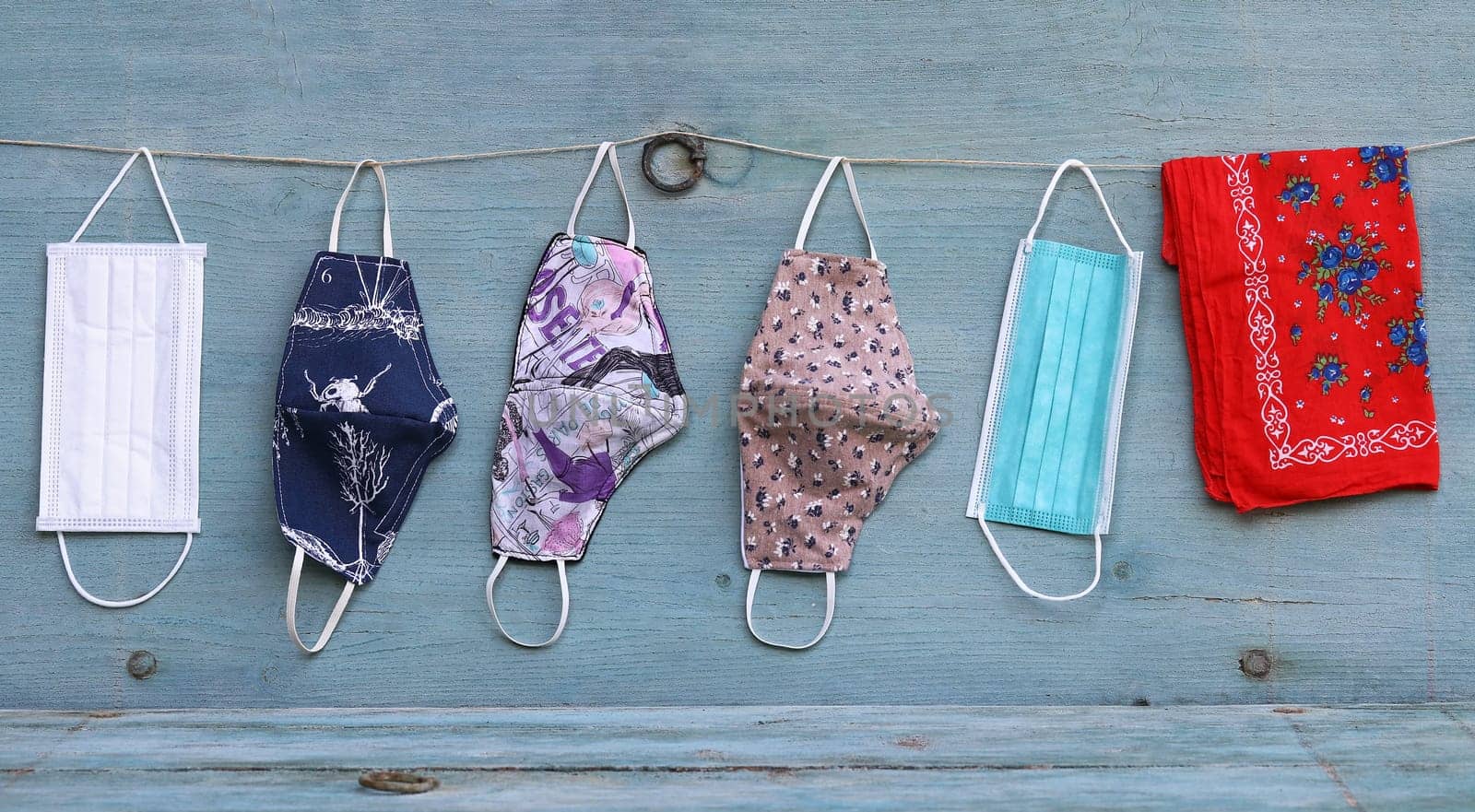 Various purchased and self-sewn protective masks, makeshift masks or scarves against the corona virus