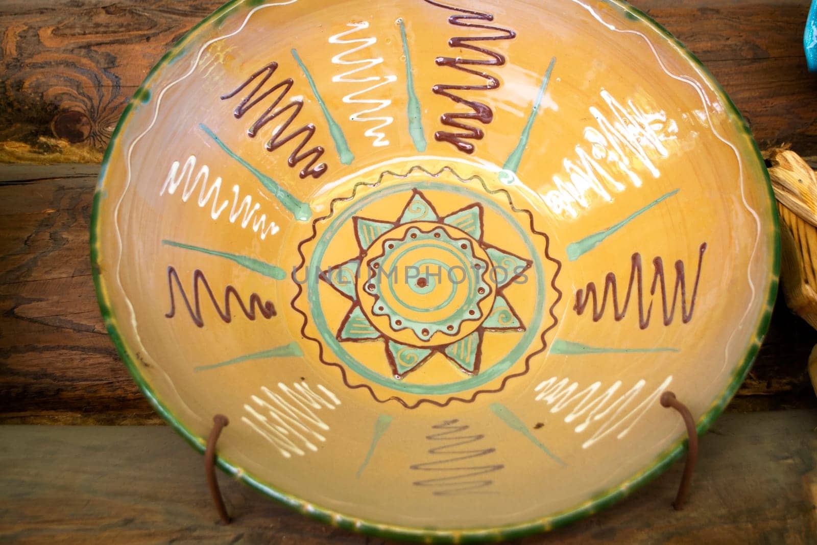 Authentic ceramic dish of Belarus with traditional pattern, on rustic wooden background