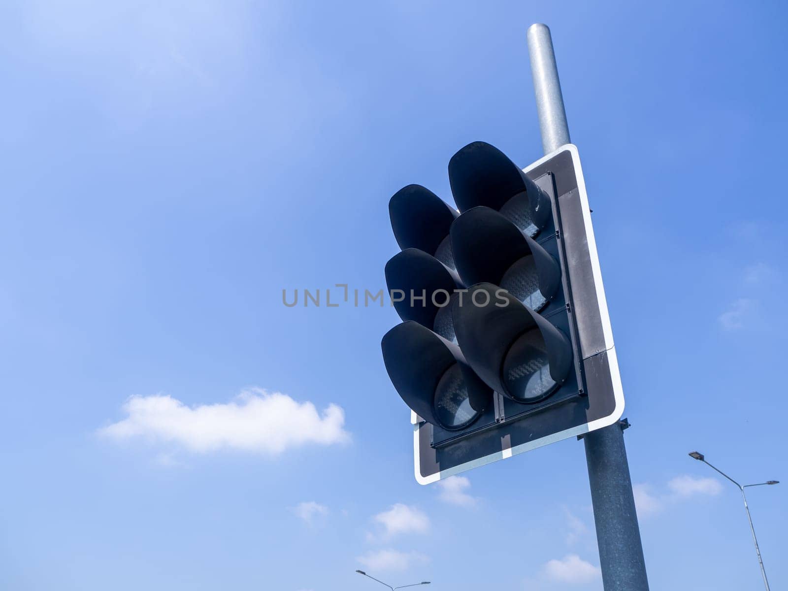 the traffic lights against a vibrant blue sky