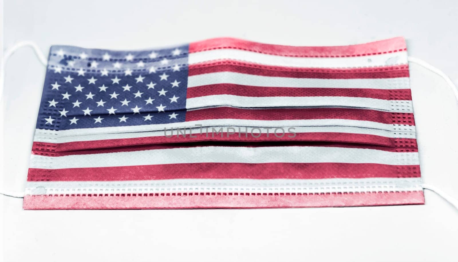 surgical mask with the USA national flag printed. Pandemic covid-19 and preventive measures to counter the spread of the virus