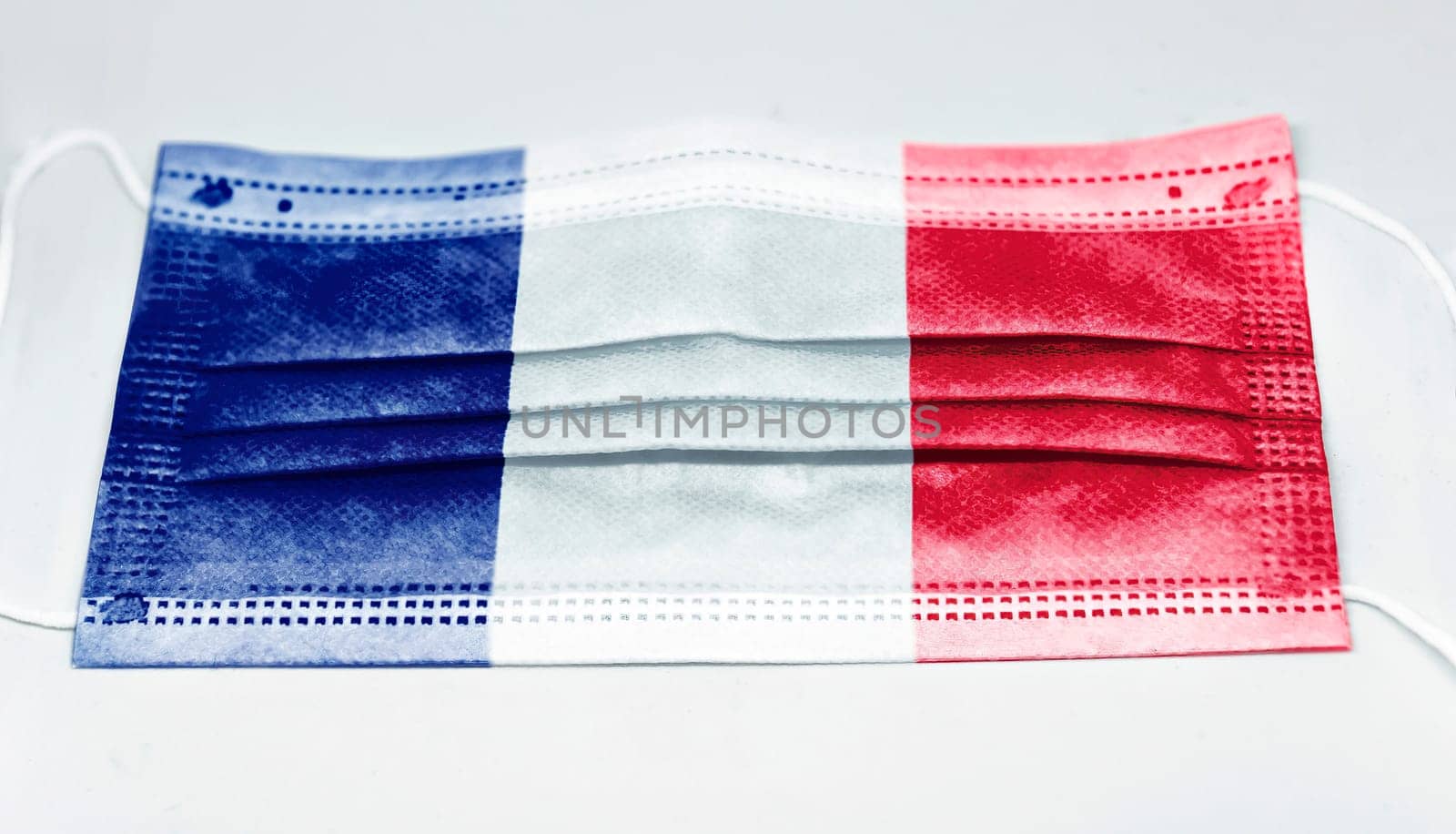 surgical mask with the national flag of France printed. Pandemic covid-19 and preventive measures to counter the spread of the virus