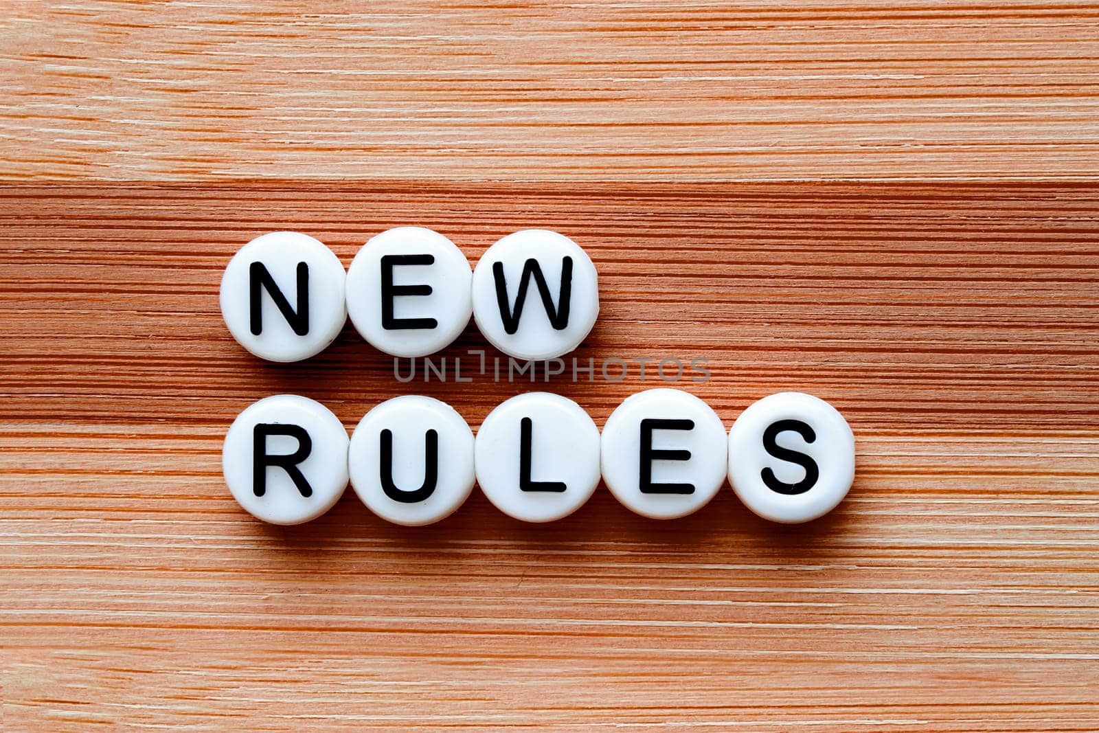 New Rules test on a brown wooden table