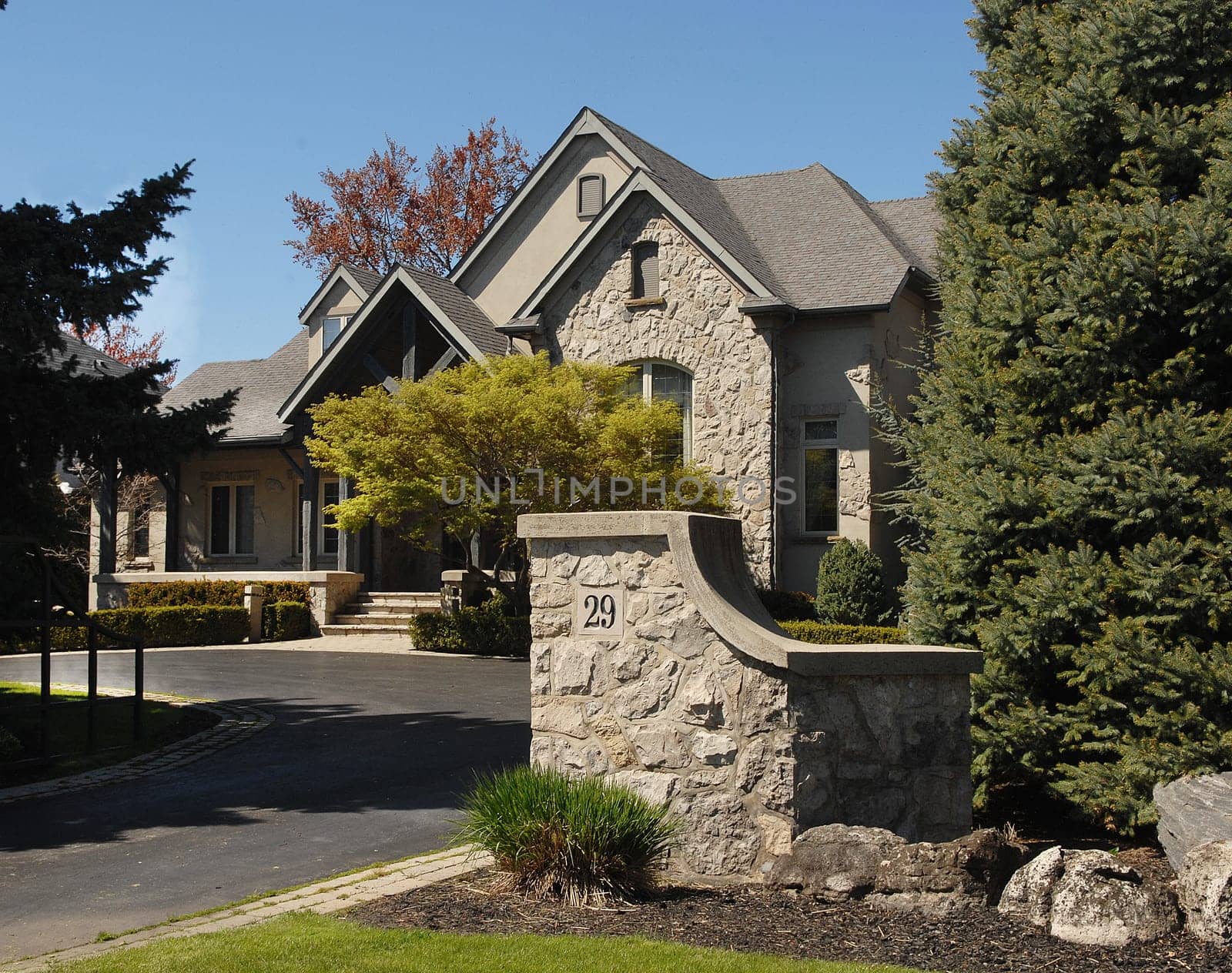 A big estate in the suburbs of the city with a big drive way and wonderful.landscape on a sunny day in the spring.