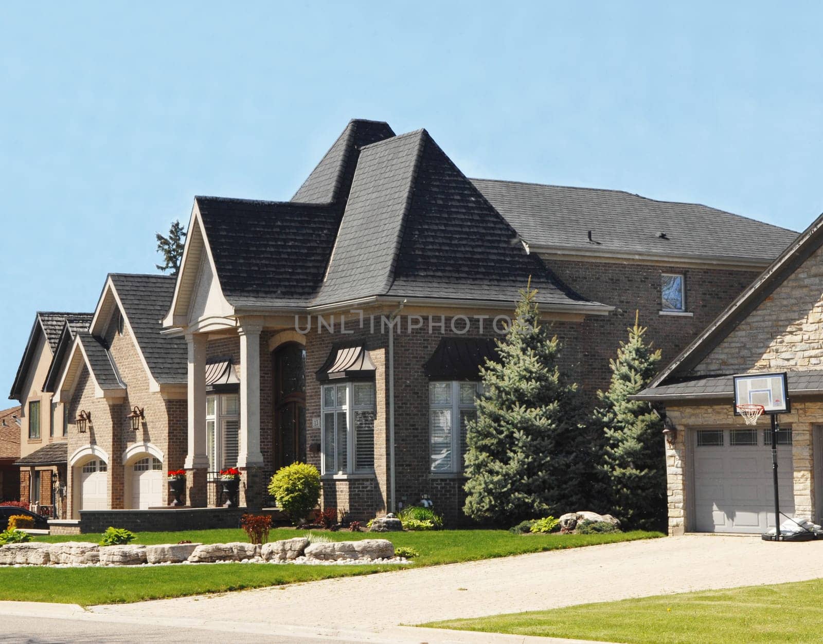 A big estate in the suburbs of the city very  expensive on a nice spring.day with blue sky.