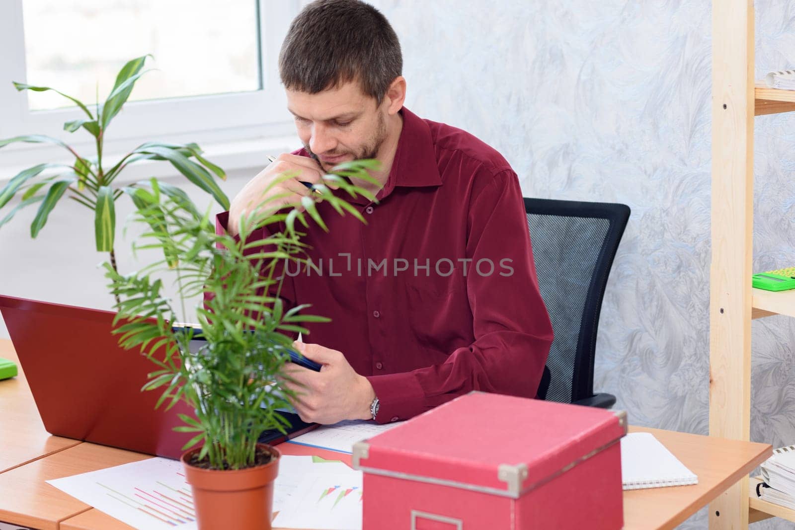 tired office worker does routine work on the desktop