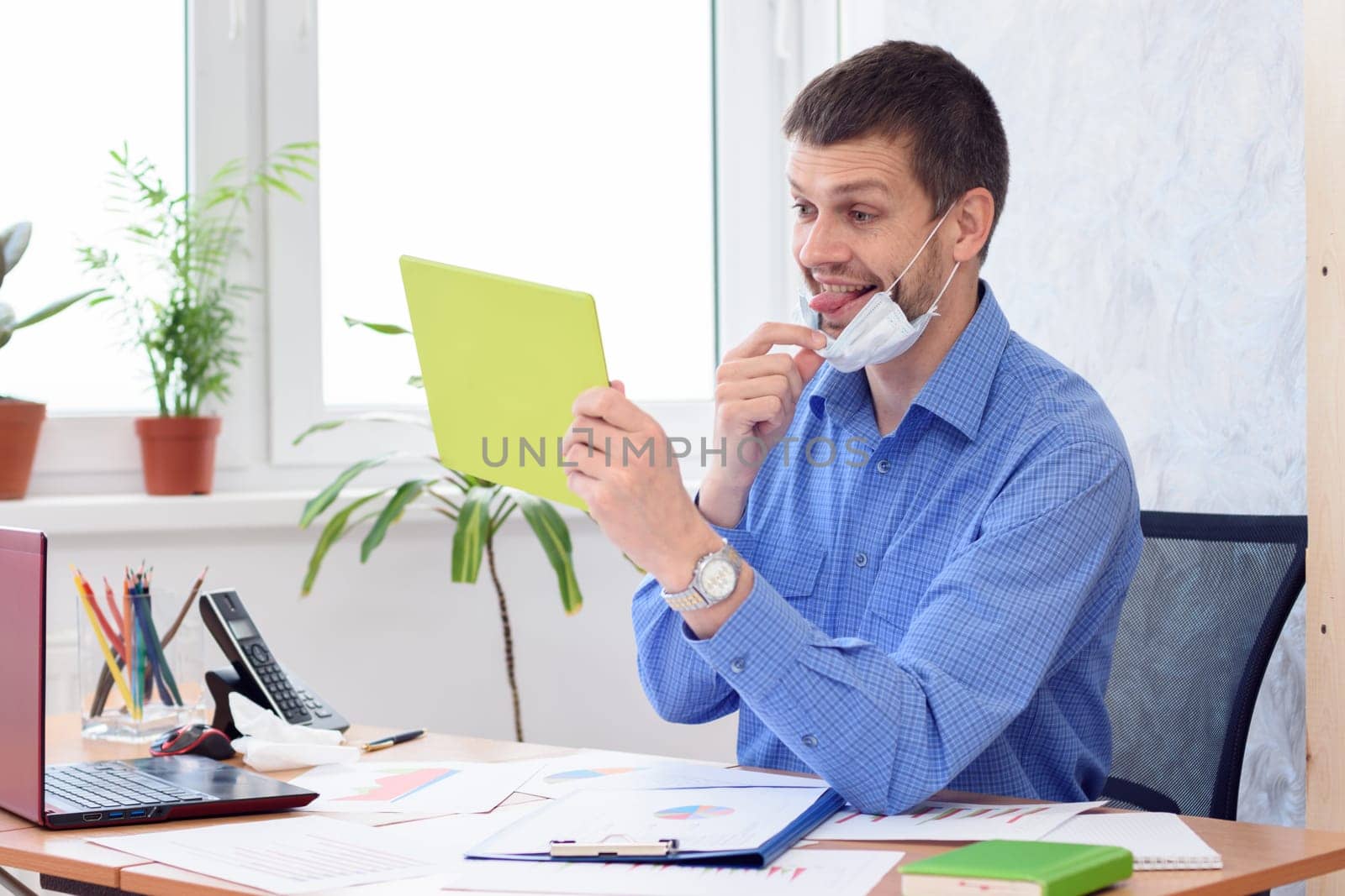 Cheerful office employee communicates with partners by video link and shows the language