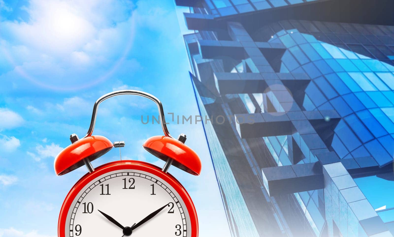 Red alarm clock on a modern townhouse and blue sky background. The concept illustration.