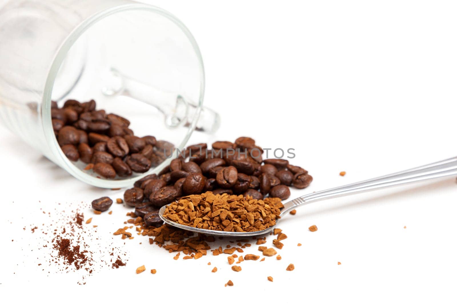 Macro shot of instant granules and beans coffee on a white background.