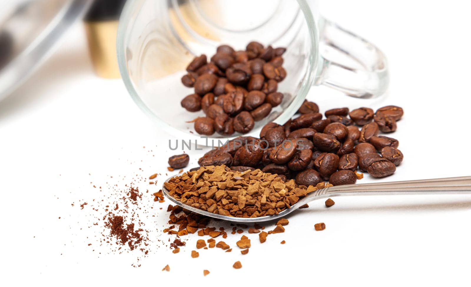 Macro shot of instant granules and beans coffee on a white background.
