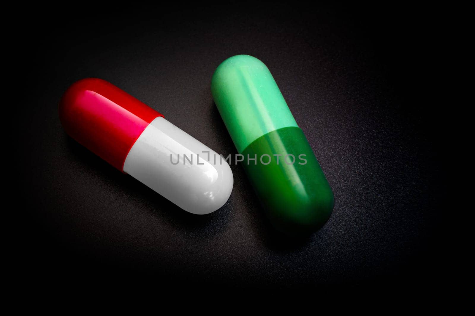 Two capsules therapy doctor flu antibiotic pharmacy medicine medical. Isolated on black background