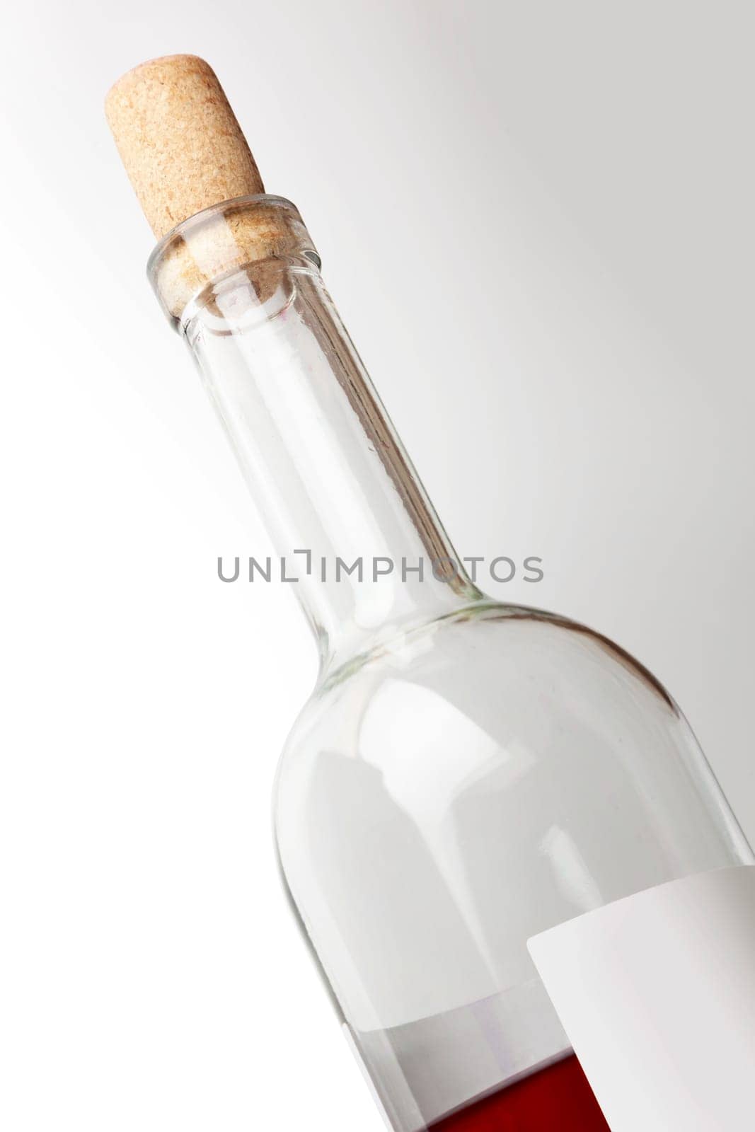 Closeup of a red wine bottle on a white background. With clipping path