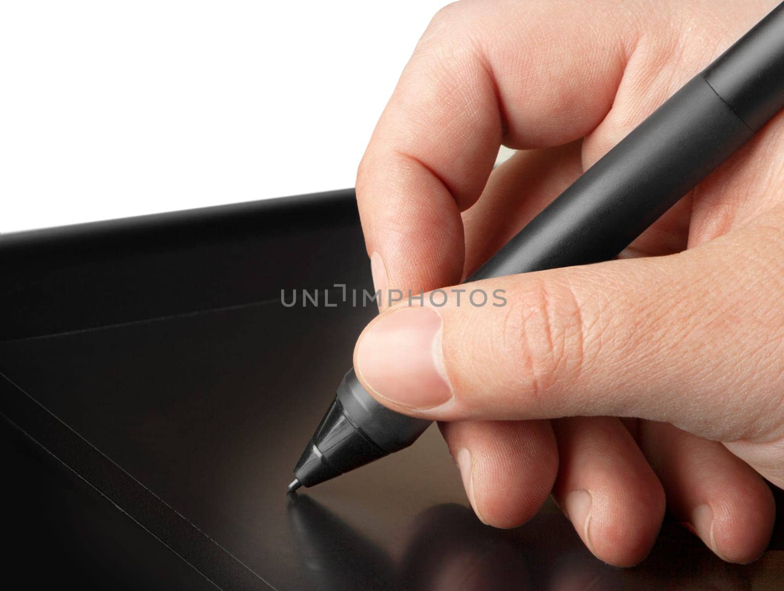 Hand is drawing on a digital graphic tablet with pen
