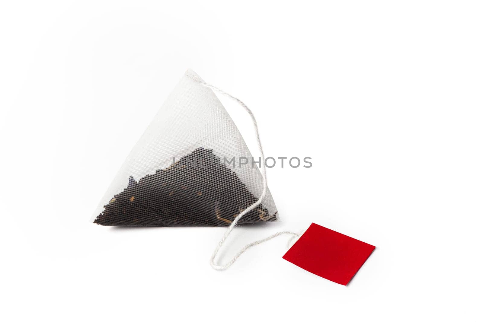 Pyramid shape teabag close up isolated on the white background