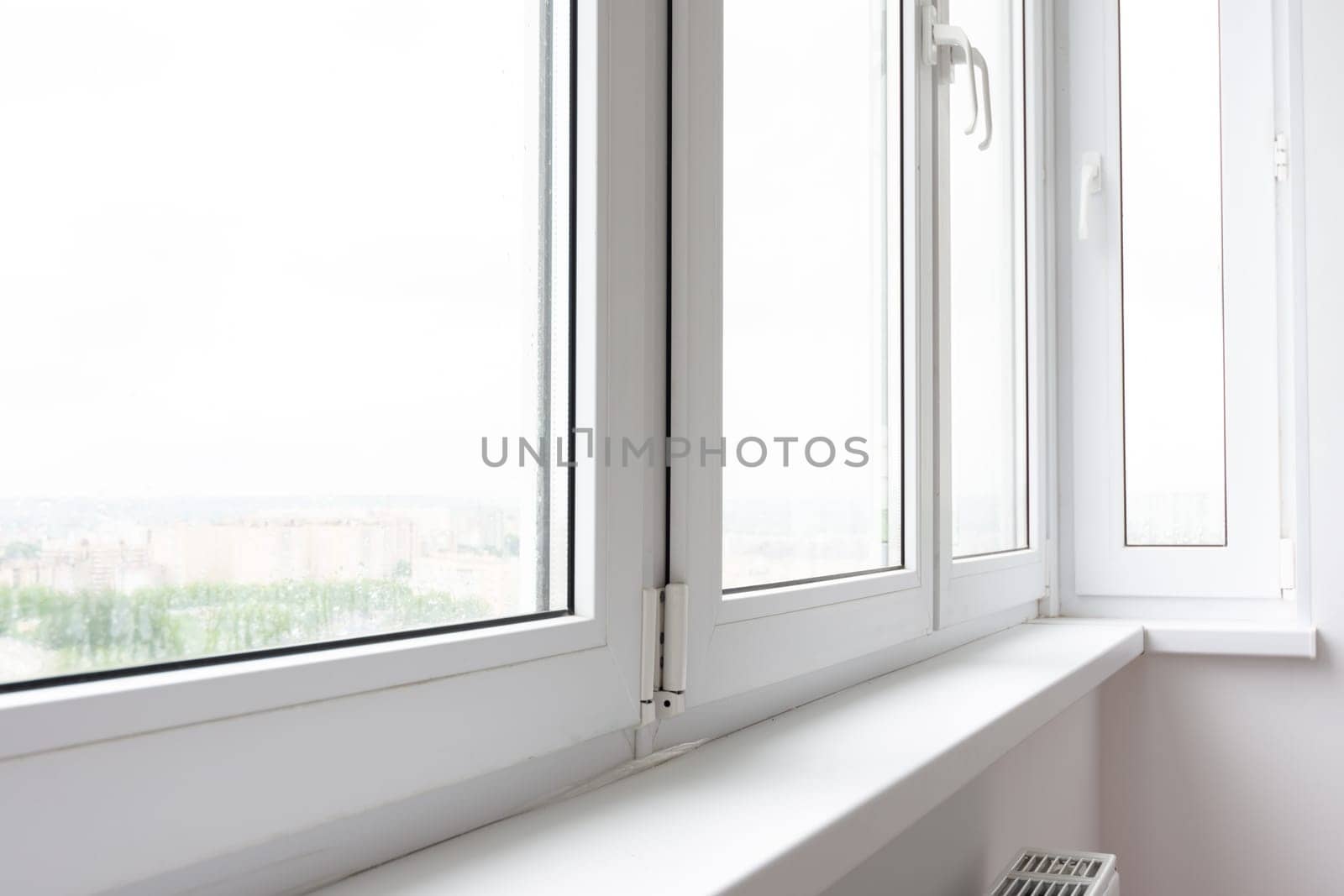 Plastic window sill on a balcony glazed with plastic windows