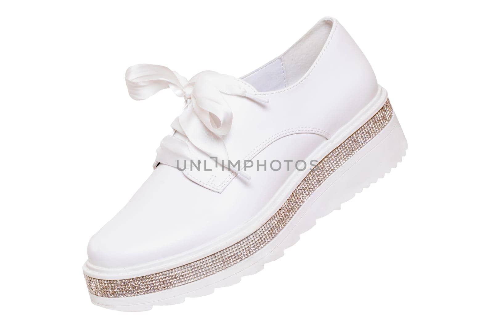 White sneaker isolated. Close-up of a single white elegant stylish female leather high-heeled sport shoes isolated on a white background. Womens shoe fashion 2020. Modern design footwear for workout. Macro.