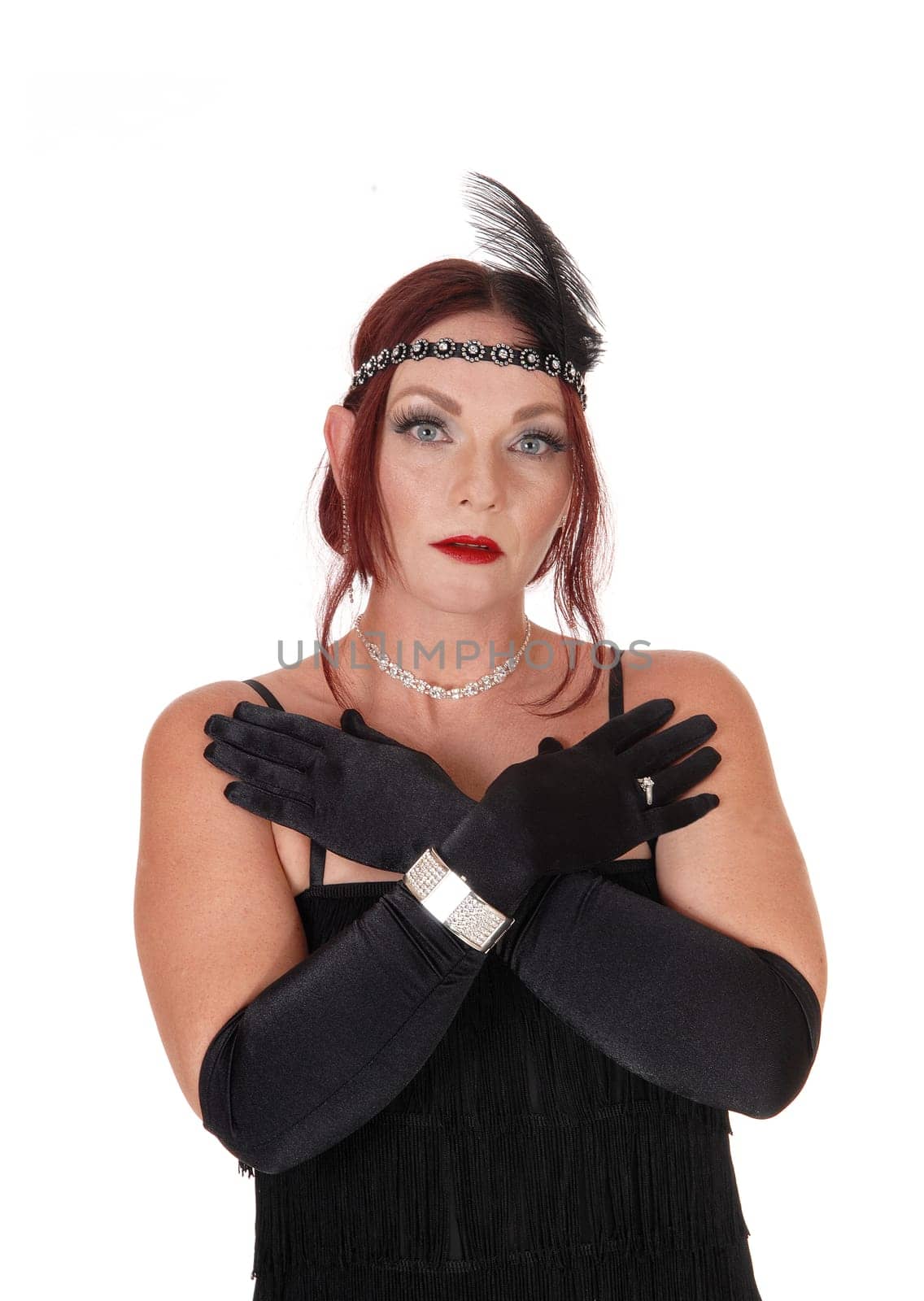 A gorgeous woman wearing a 20 century black dress with the head.band and black cloves, isolated for white background.