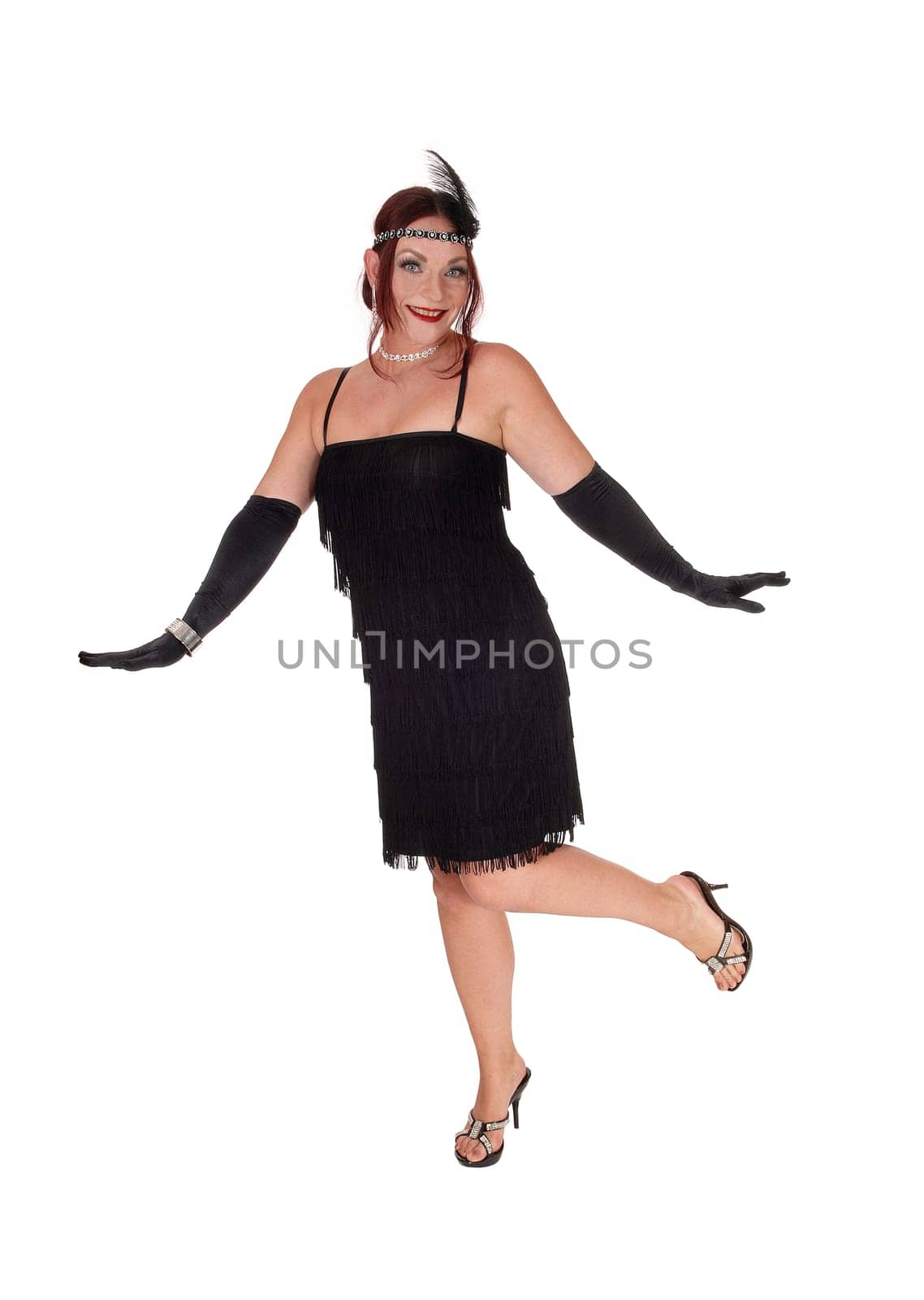 A gorgeous woman in a black dress of the 20 century and long cloves.dancing in the studio, isolated for white background.