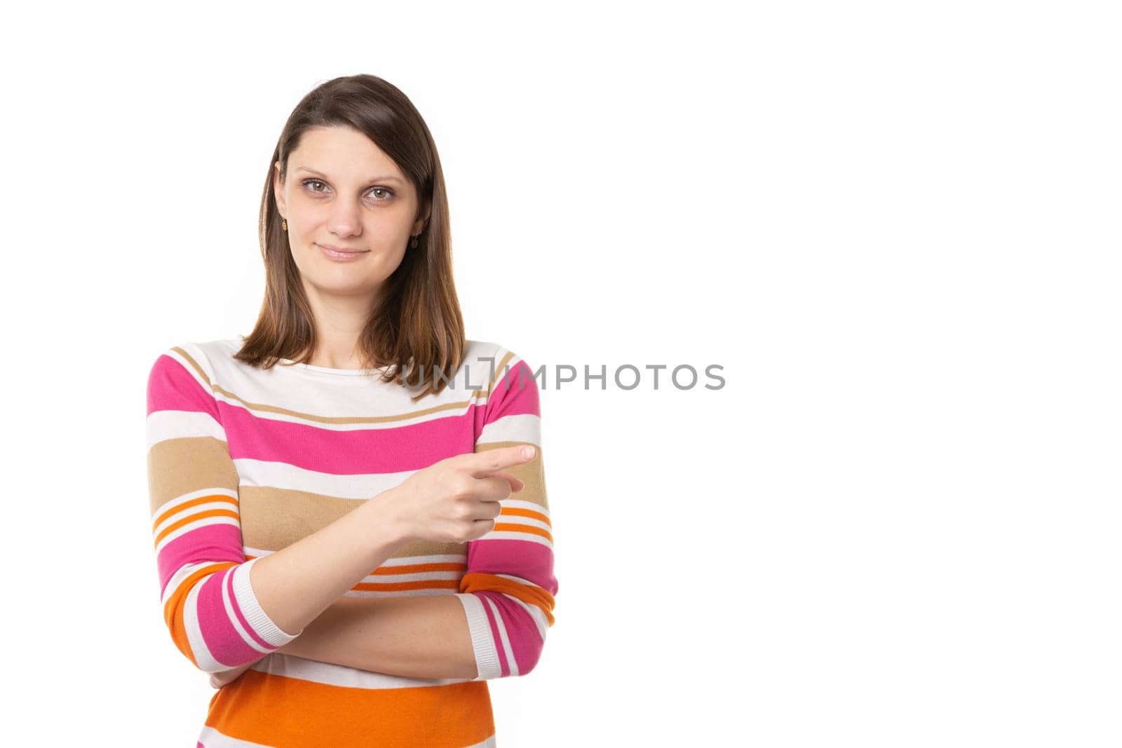 Portrait of a beautiful girl of thirty years of European appearance on a white background, the girl points a finger to an empty place
