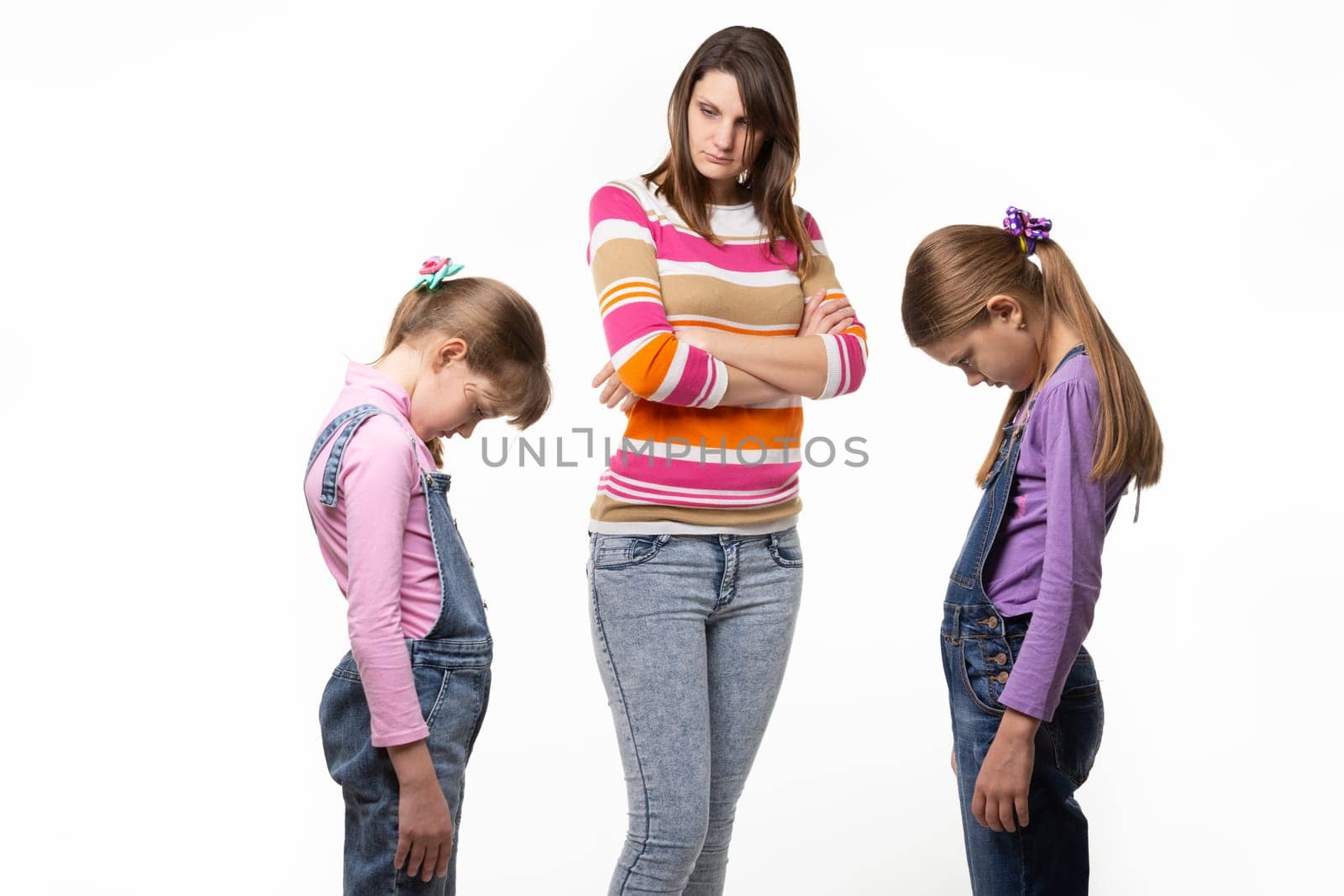 The girls are ashamed in front of their mother, their mother scolds them