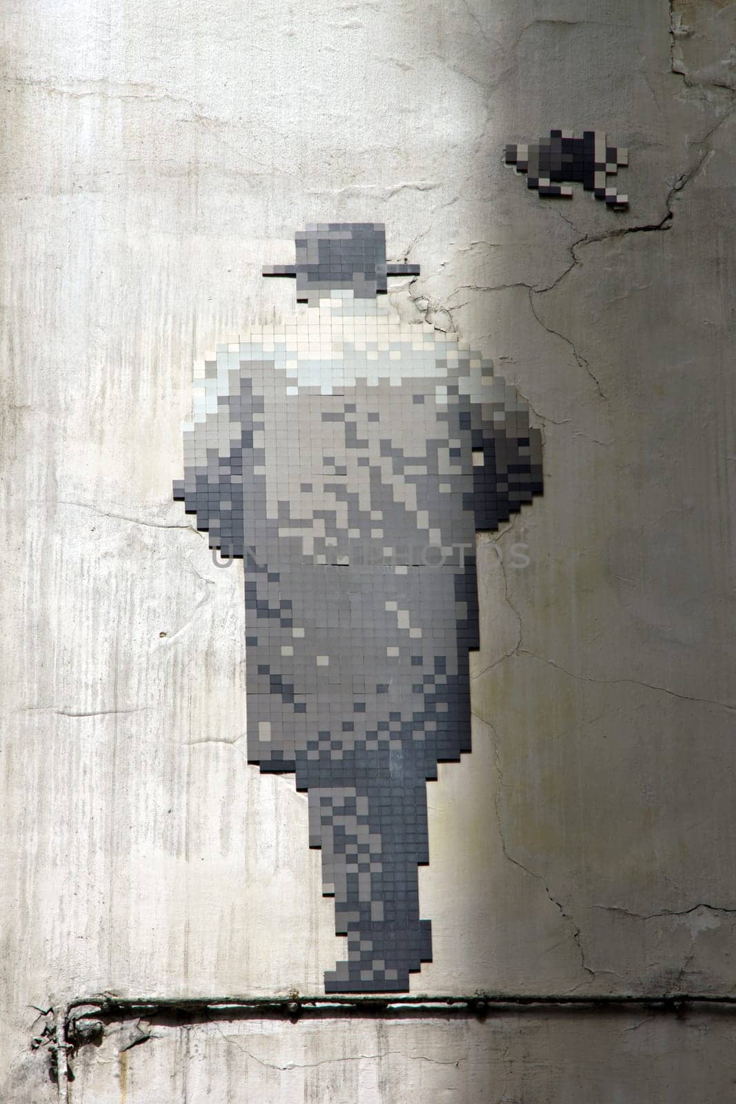 Street art. Back man in mosaic. The walking man. Paris 6th district France