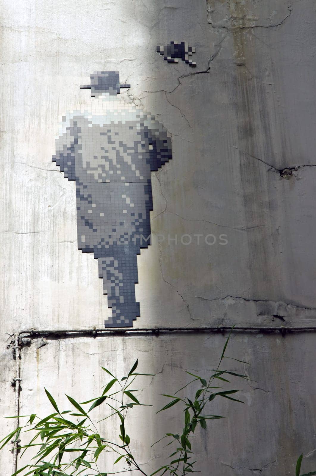 Street art. Back man in mosaic. The walking man. Paris 6th district France