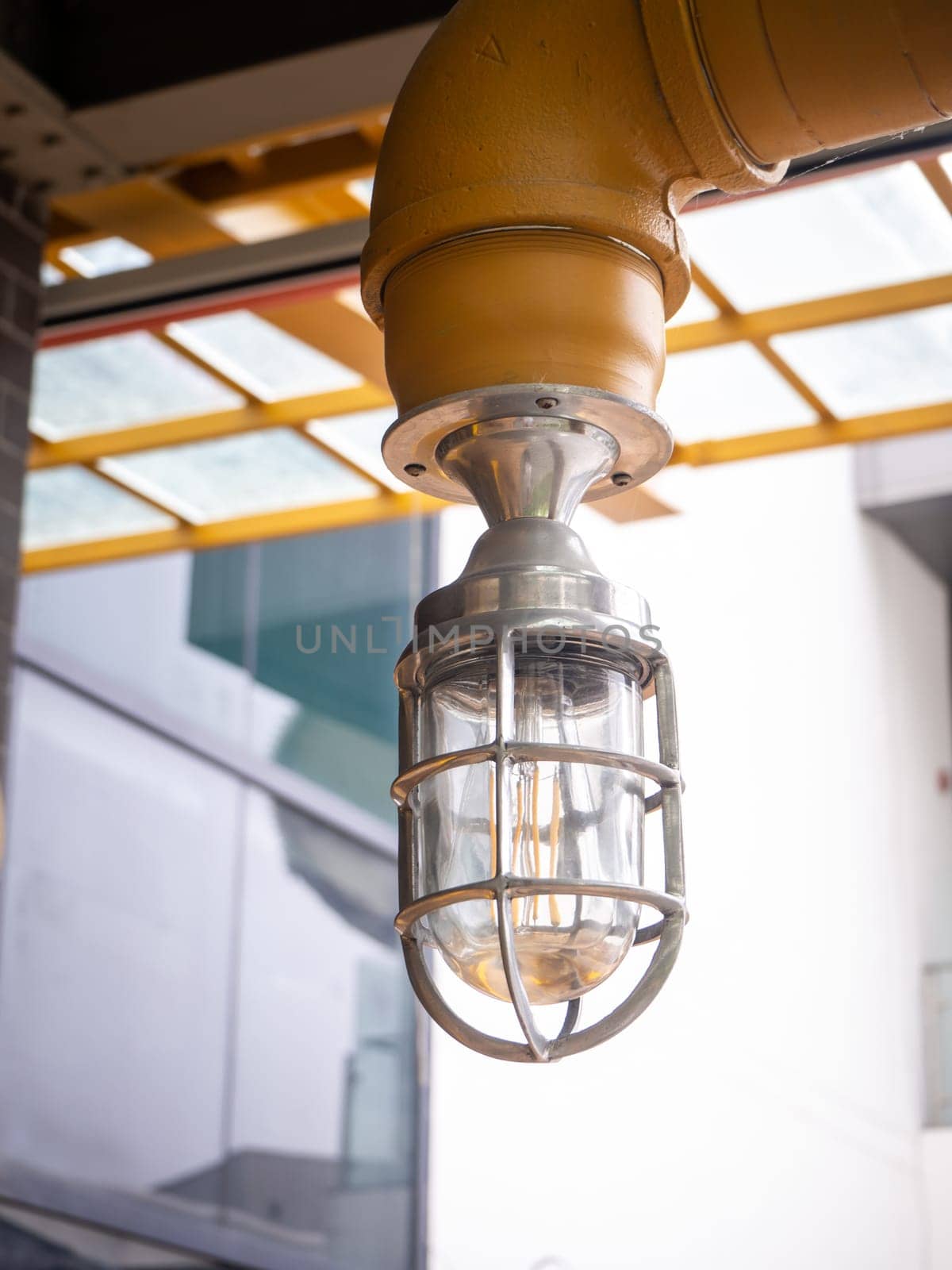 Loft style light bulbs glowing near window. Warm light. Coffee shop interior.