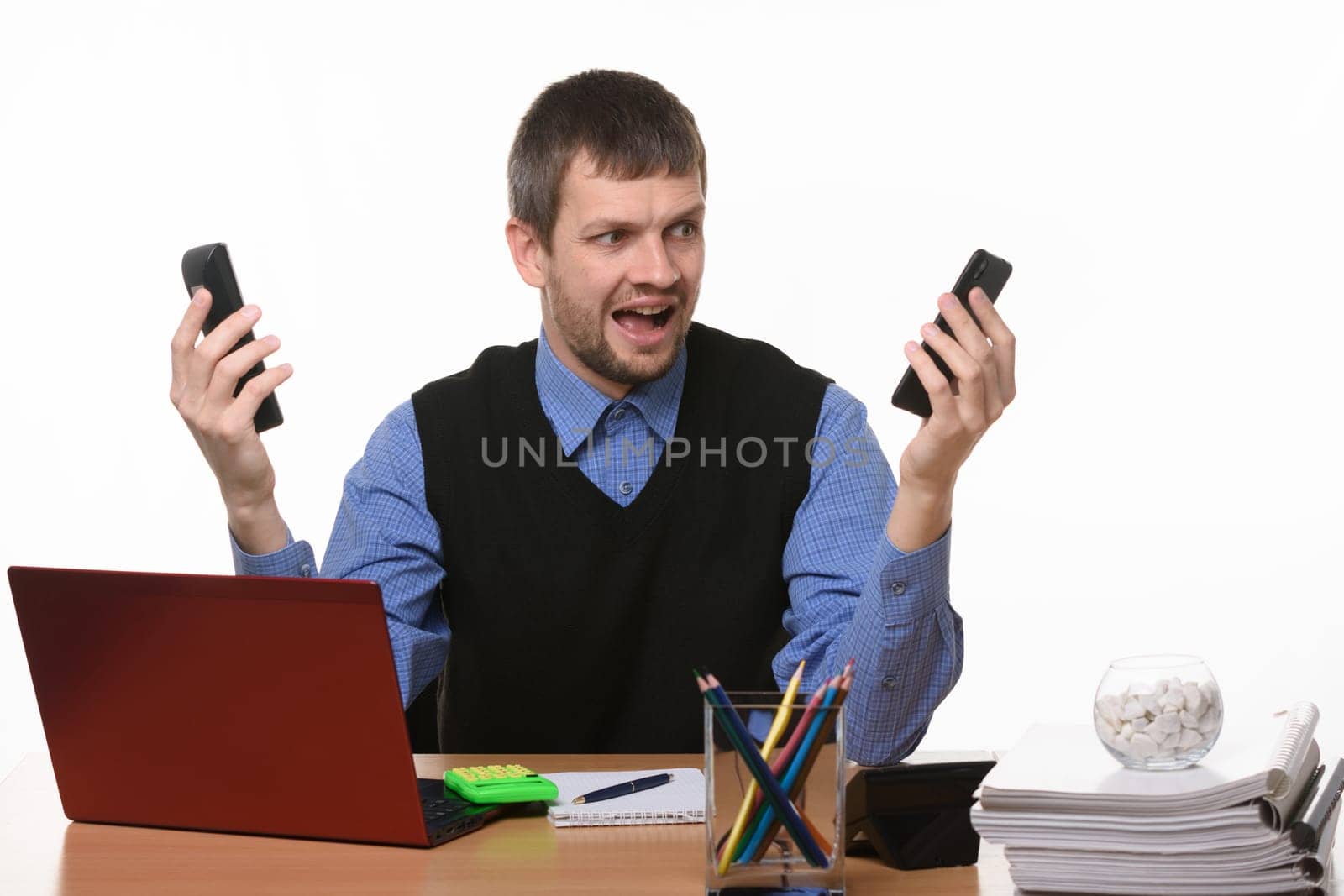 man with two phones in shock looks at them