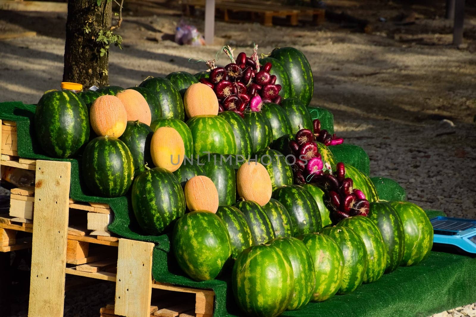 Selling vegetables and watermelons by the road. Resort shops by the road for tourists.