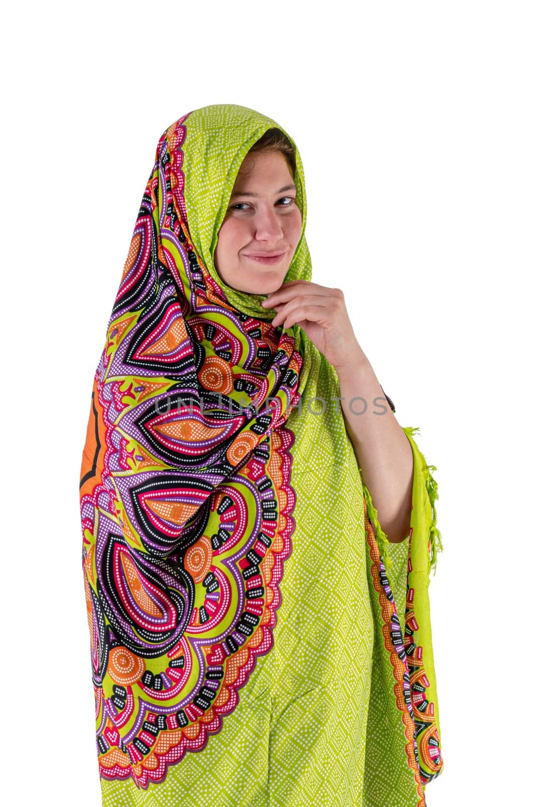 Smiling young girl with a green headscarf looks into the camera isolated on white
