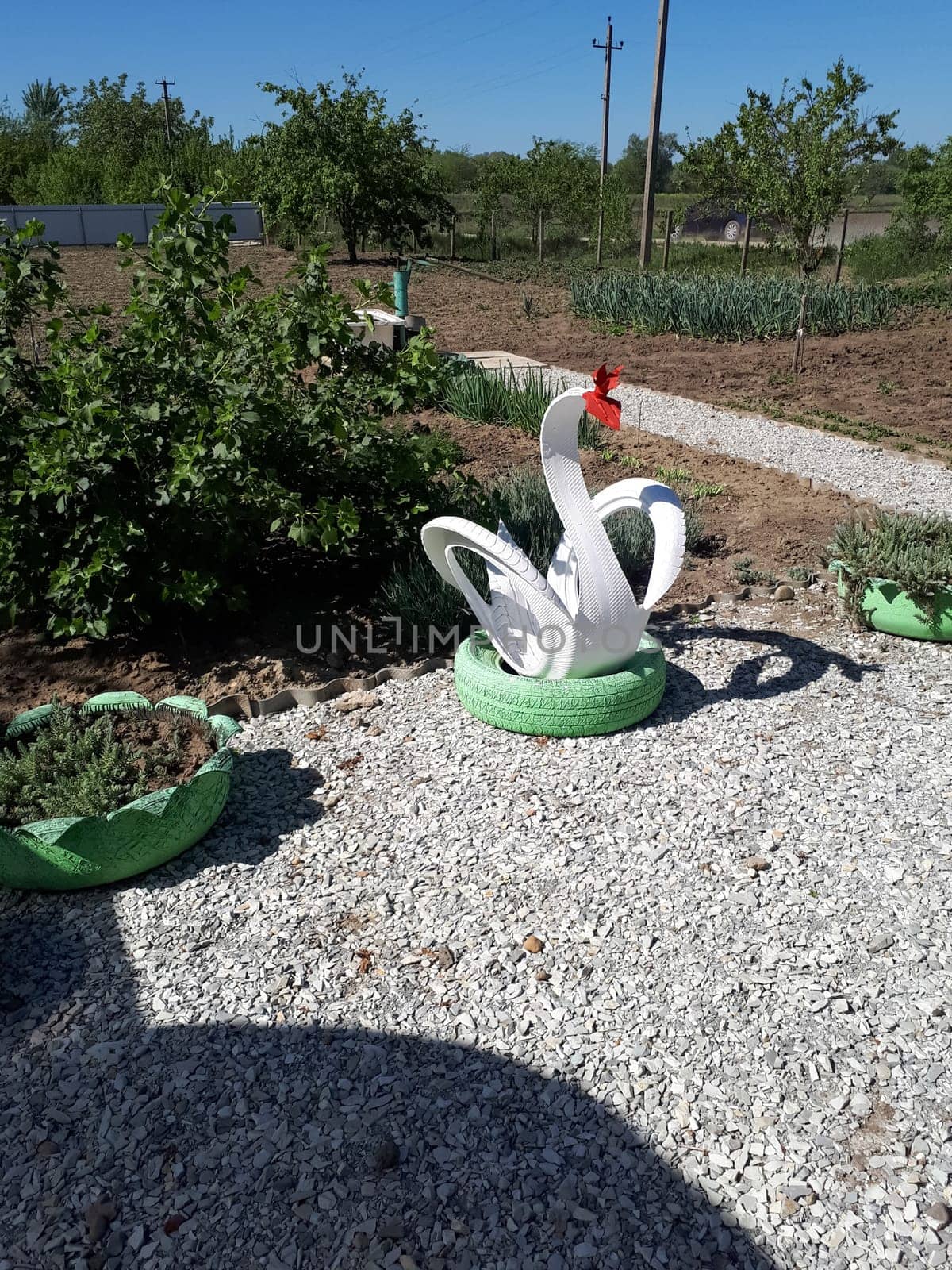 Craft from a rubber tire - a white swan. Decorations in the garden.