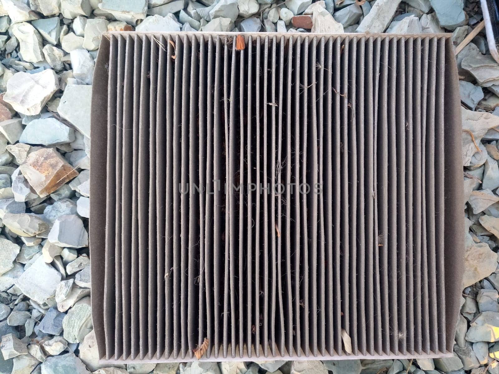 An old dirty filter out of the car. Replacing the air filter.
