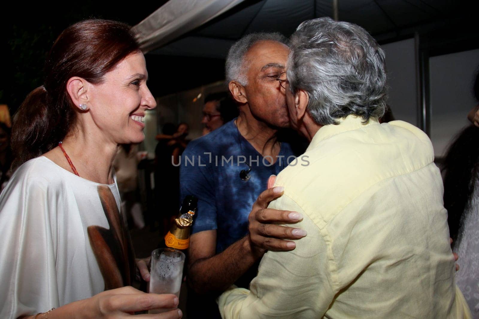 salvador, bahia / brazil - december 31, 2013: Singers Caetano Veloso and Gilberto Gil kiss each other during New Year's Eve festivities in Salvador.