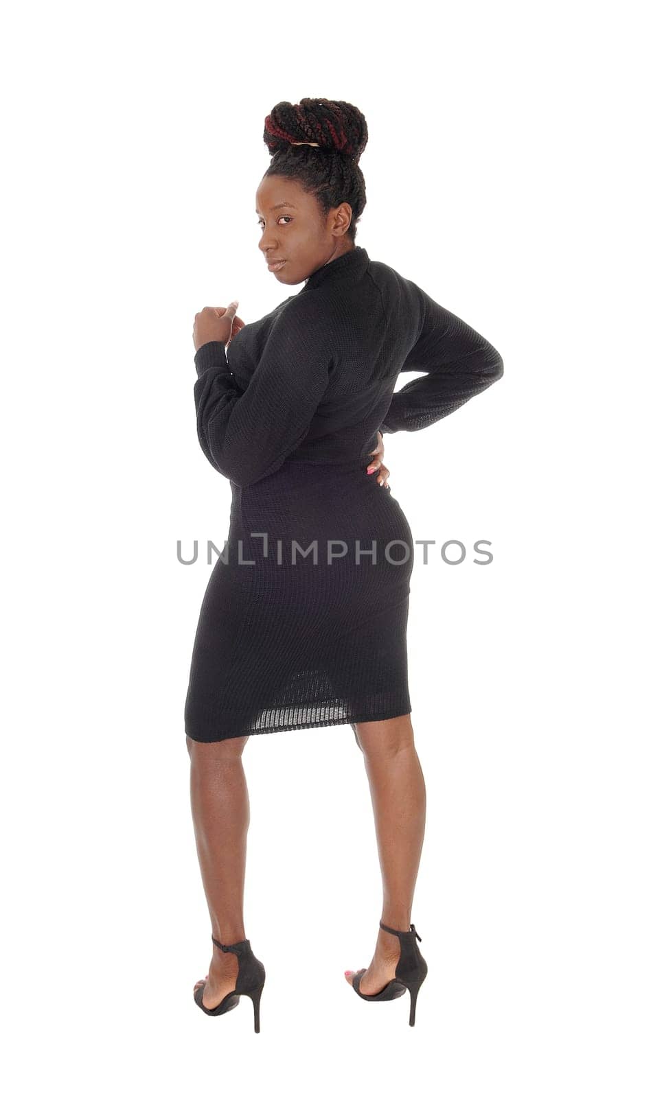 A beautiful young African American female standing in a tight.gray dress, showing her figure, isolated for white background.