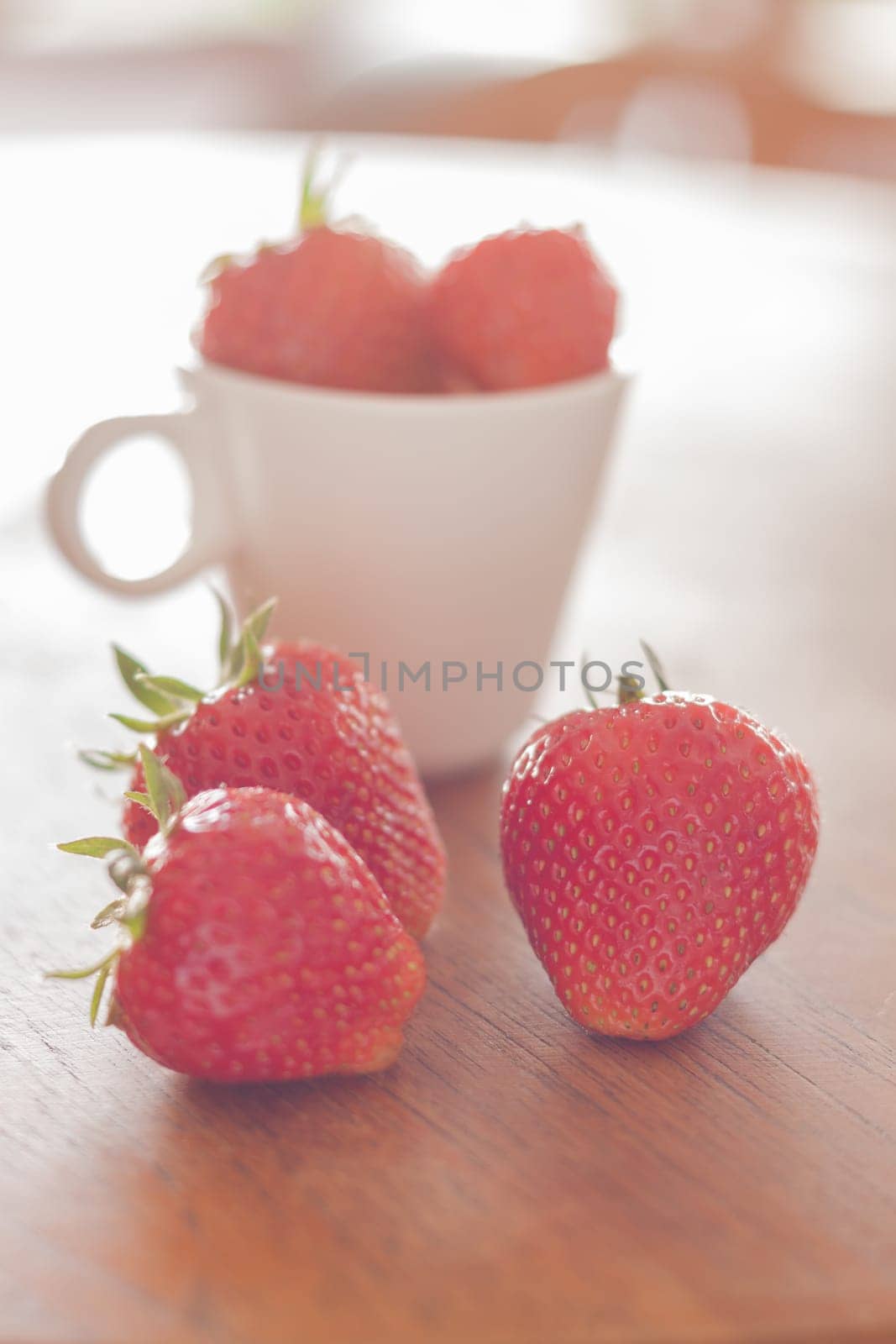 Fresh strawberries on wooden table, stock photo