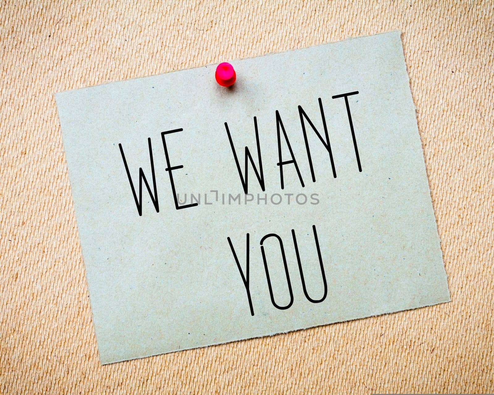Recycled paper note pinned on cork board.We want you Message. Concept Image
