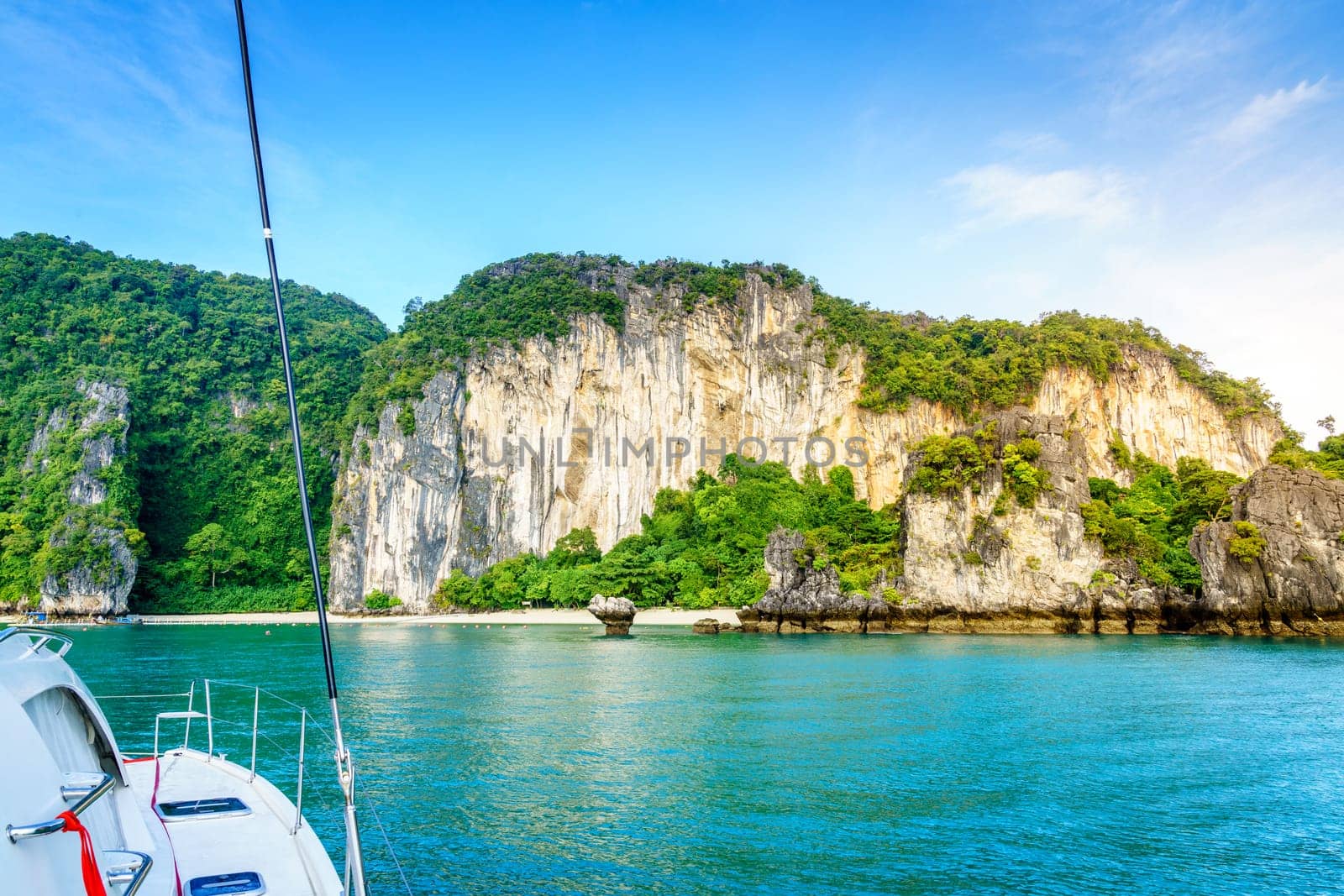 Sailboat approaching a beach on an island in the Andaman Sea, Thailand