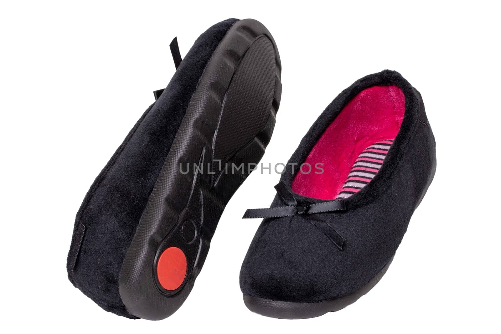 Slippers isolated. Close-up of a pair of black female house slippers or ballerina shoes isolated on a white background. Macro of woman shoes.