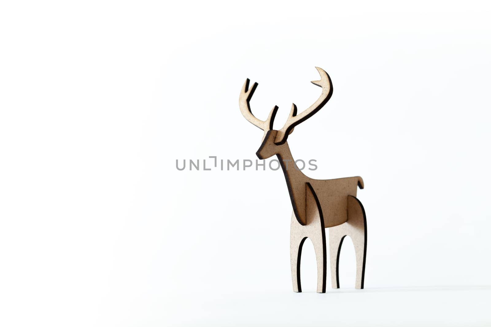 Single reindeer cardboard toy isolated on a white background. Christmas icon with Text space