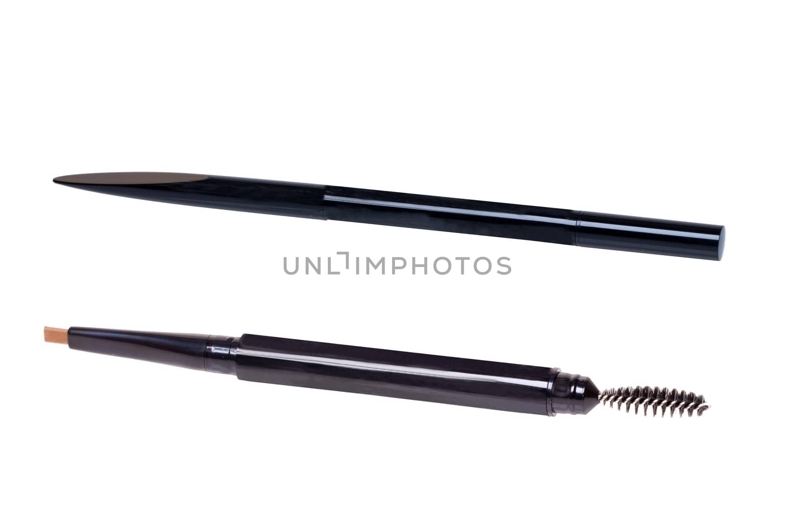Cosmetic tools. Macro photograph of a slanted professional eyebrow pencil and brush isolated on a white background.