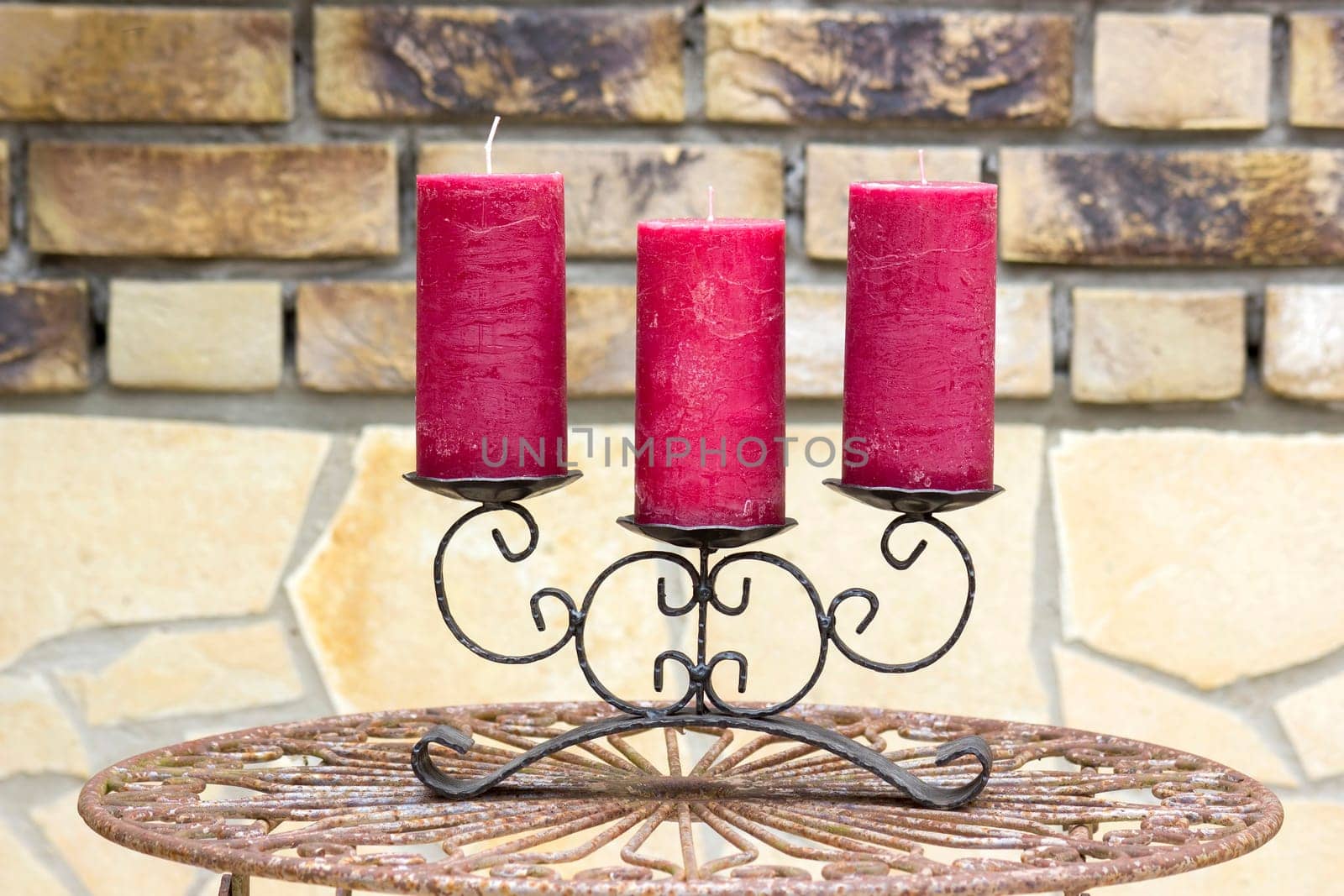 Retro candlestick with candles on old metal table